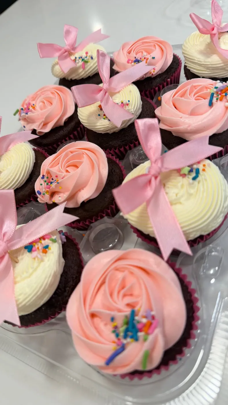 Pink rosette cupcakes finished with satin bows