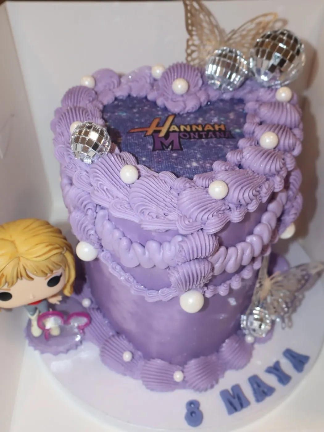 Lavender vintage heart cake with pearls, disco balls and butterflies for a Hannah Montana birthday