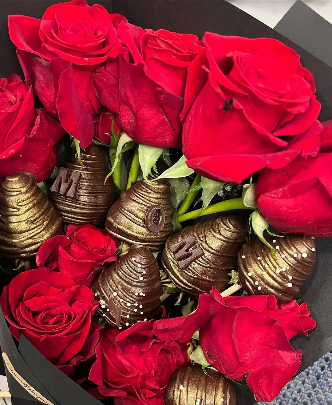 Red roses arranged with gold-dipped strawberries